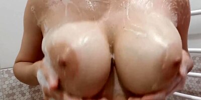 Big natural boobs in foam close up